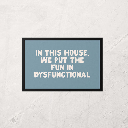 Framed poster with text 'In this house, we put the fun in dysfunctional' on a light gray background