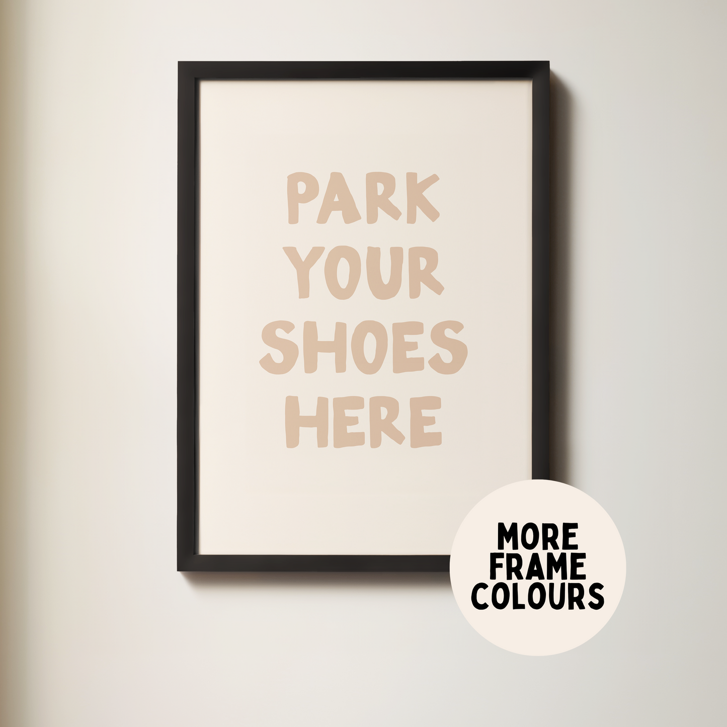 Framed poster with 'Park Your Shoes Here' text on a plain wall.