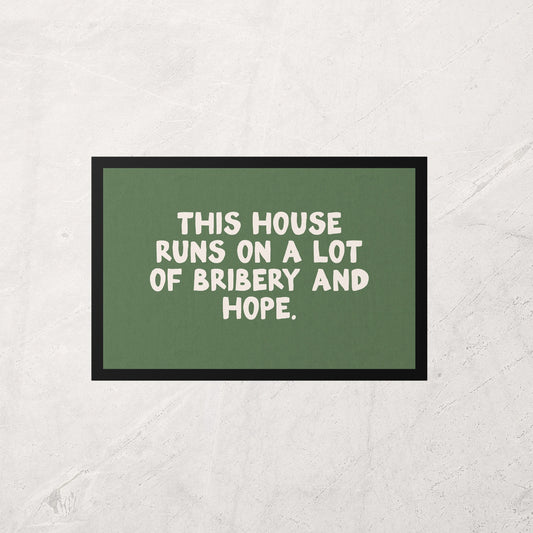 Green sign with white text on a textured wall