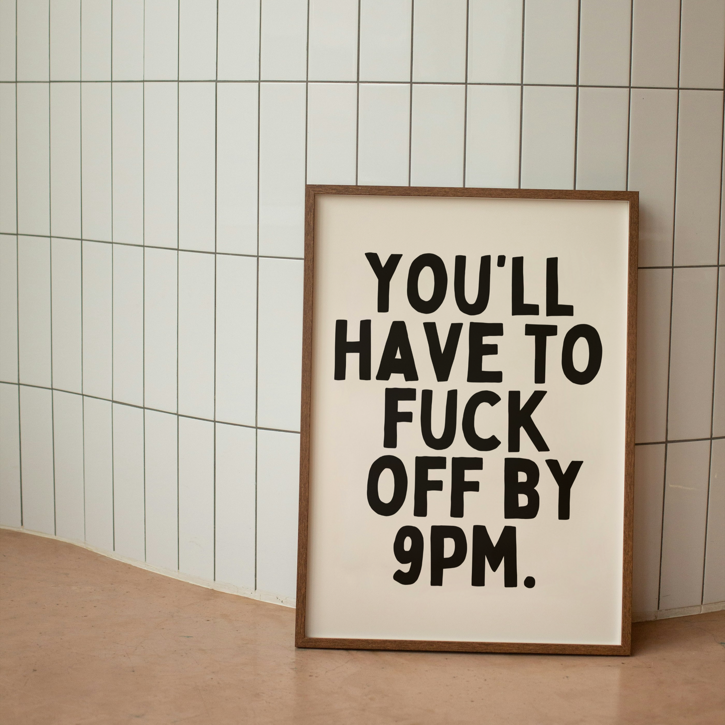 Framed poster with text on a tiled wall