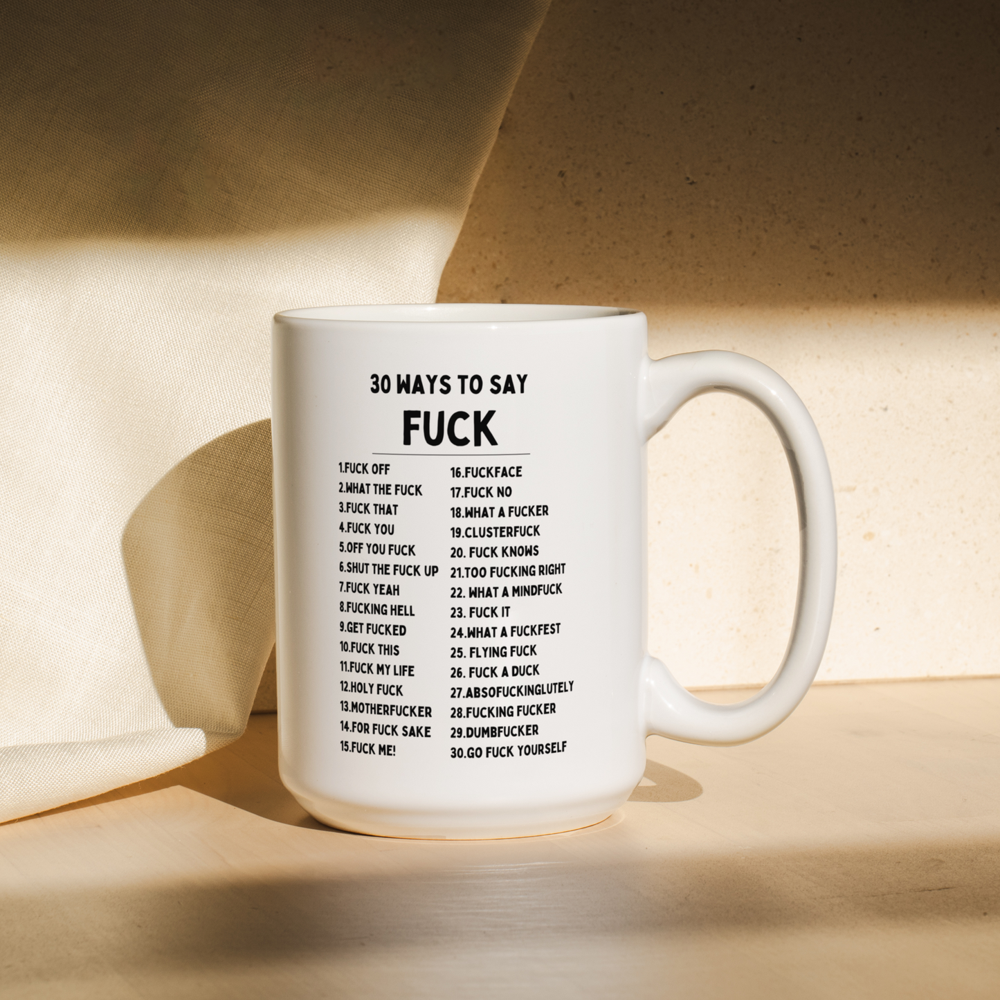 White mug with text on a wooden surface
