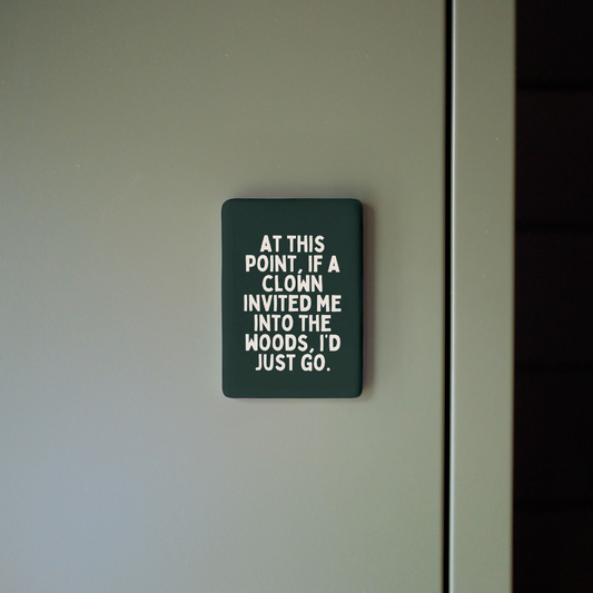 Sign on a door with humorous text about clowns and wood.