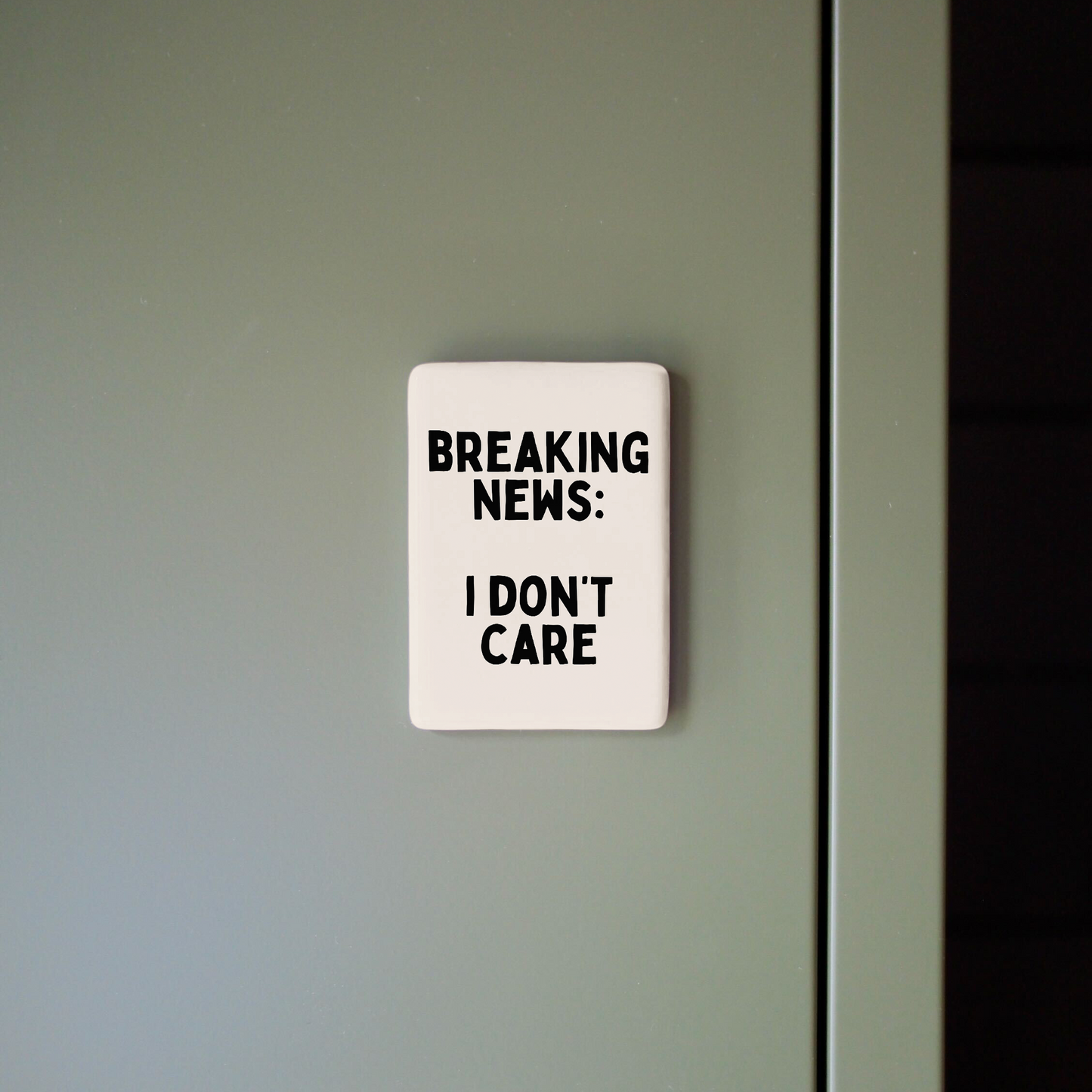 Sign on a door with text 'BREAKING NEWS: I DON'T CARE'