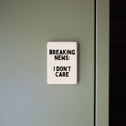 Sign on a door with text 'BREAKING NEWS: I DON'T CARE'