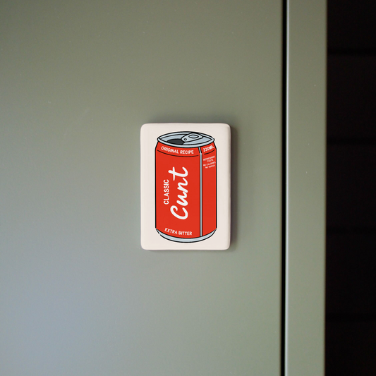 Fridge magnet with a red can design on a gray surface