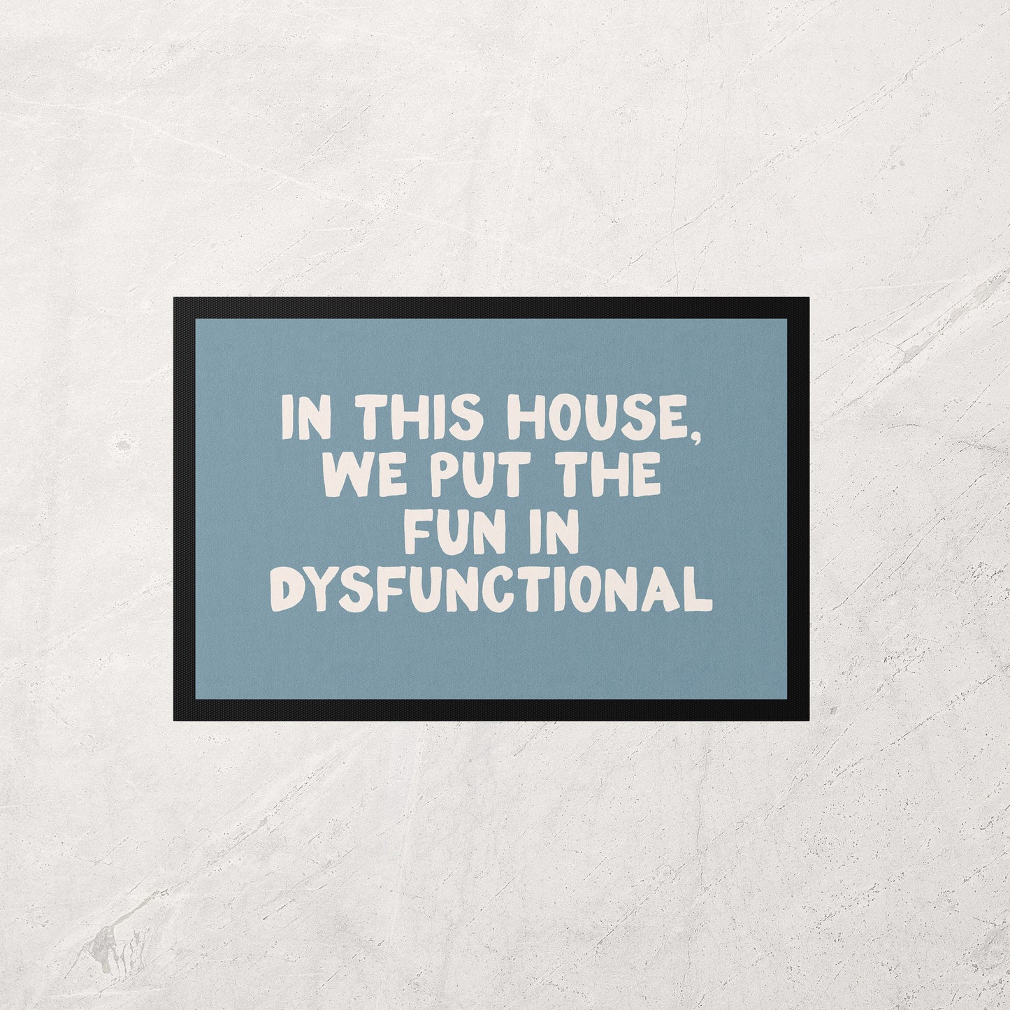 Framed poster with text 'In this house, we put the fun in dysfunctional' on a light gray background