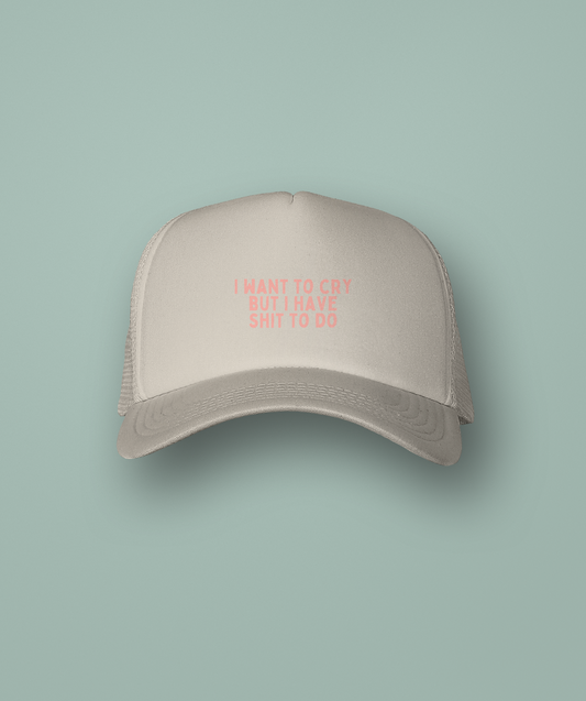 Beige cap with pink text on a light green background