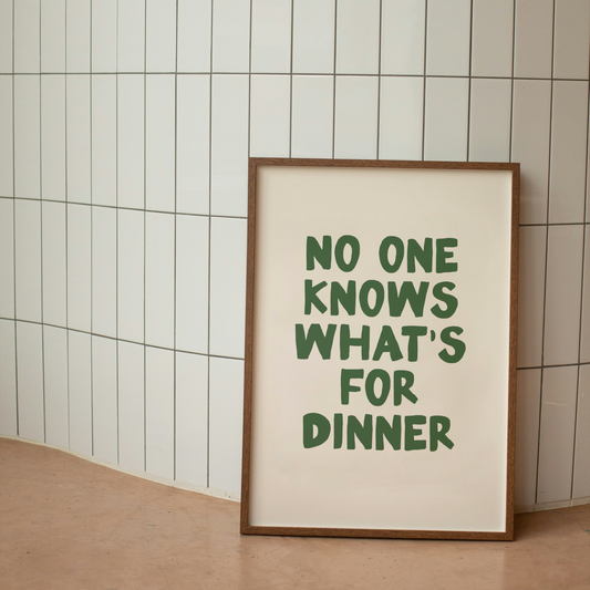 Framed print with 'No one knows what's for dinner' text on a tiled wall.