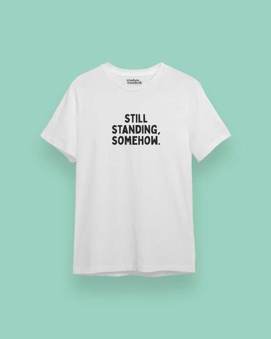 WISDOM & WONDER DESIGNS X POTS UK | Still Standing. Somehow | Organic Unisex T Shirt