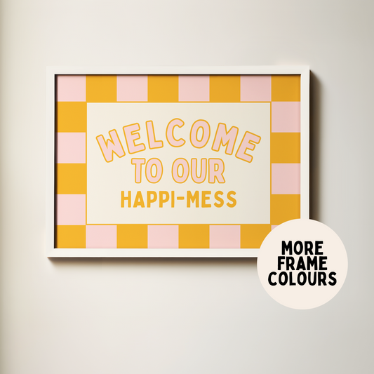 Framed artwork with 'Welcome to our happi-mess' text on a checkered background, with a label indicating more frame colors.