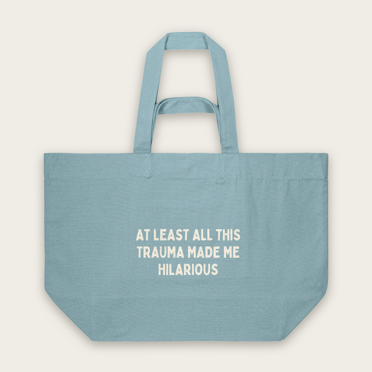 At Least All This Trauma Made Me Hilarious | Tote Bag in Pebble Blue (18451_At-Least-All-This_STAU117_Pebble-Blue_Tote-Bag_Mockup.png)
