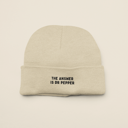 Beige beanie with 'The Answer is Dr Pepper' text on a beige background